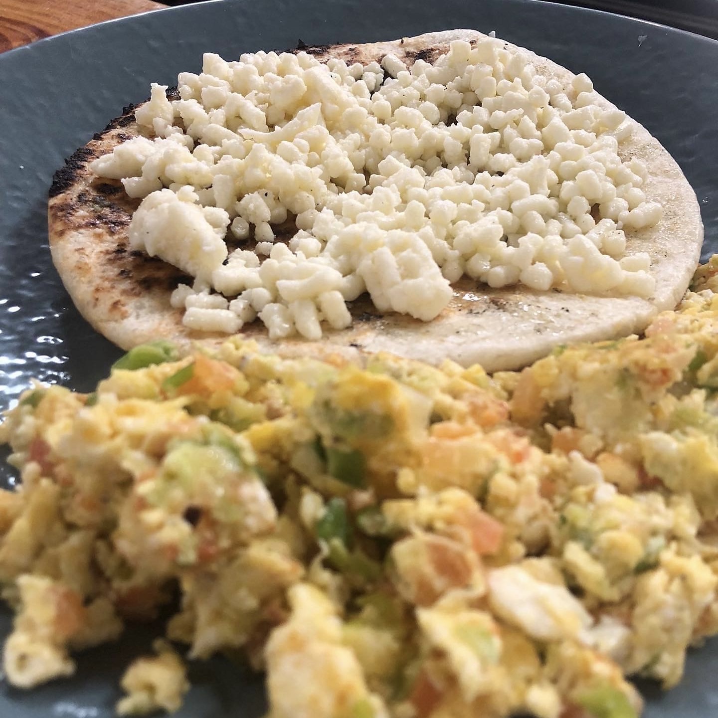 Scrambled Eggs with an Arepa with Cheese