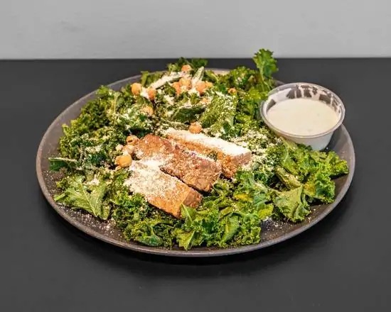Kale Caesar salad with tempeh, sweet potato and vegetables