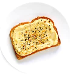 Hummus Toast with Cucumber, mix greens, black pepper and olive oil on 7 Grain Toast